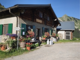 Traditional alpine dairy building on a farmed alp
