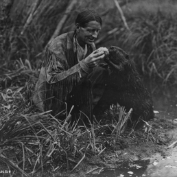 Belaney/Grey Owl feeding a beaver in 1931.